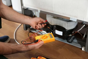 Technician repairing a refrigerator